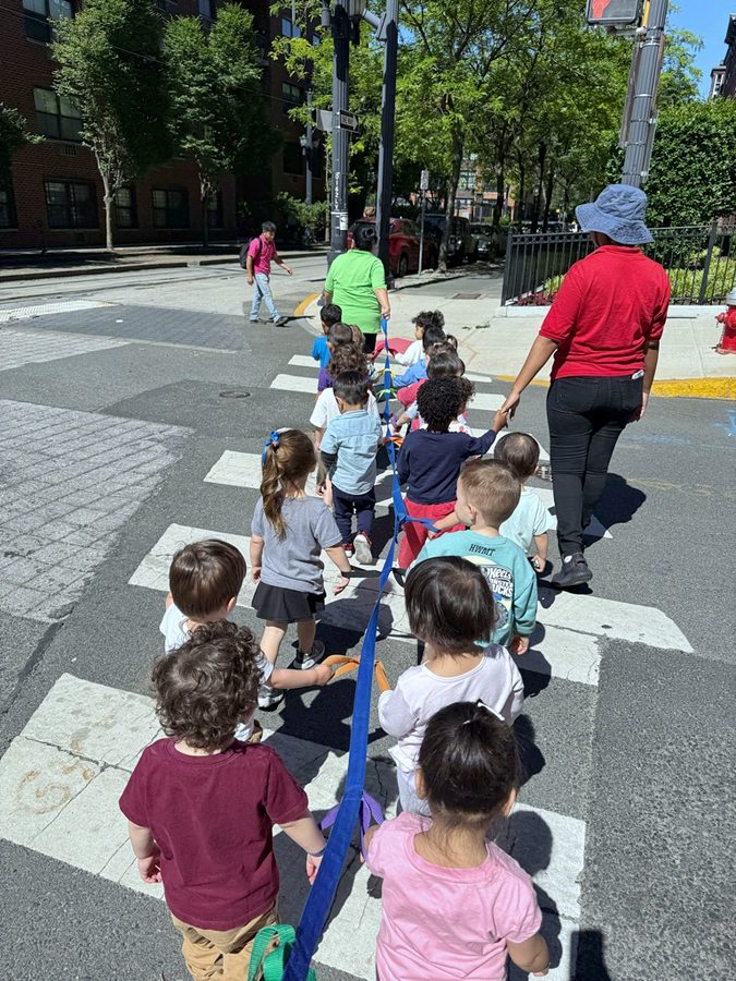 Older children walking together on a city crosswalk